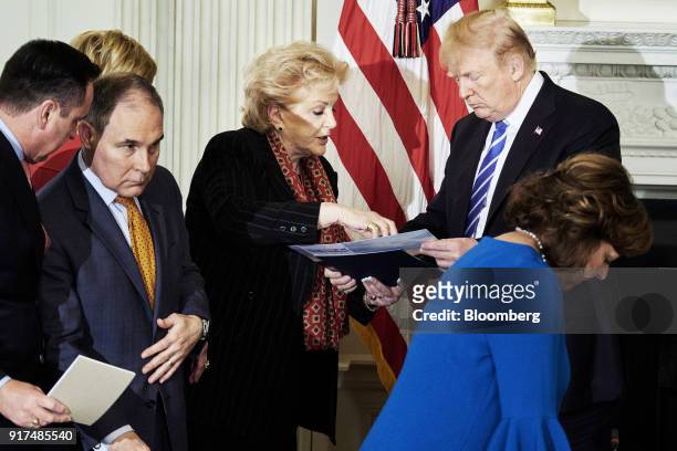 President Donald Trump speaks with Carolyn Goodman, mayor of Las Vegas, center, following an infrastructure initiative meeting at the State Dining...