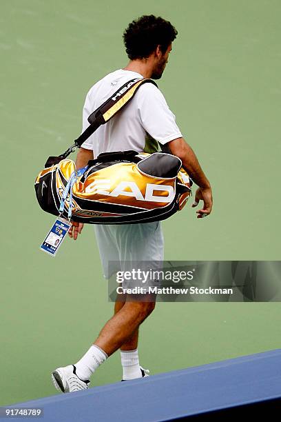 Jose Acasuso of Argentina leaves the court after retiring from his match against Andreas Beck of Germany during day one of 2009 Shanghai ATP Masters...