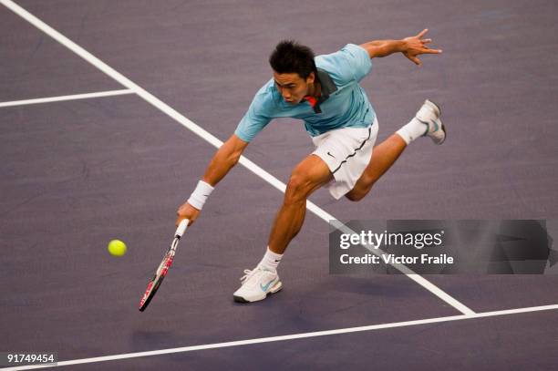 Shao-Xuan Zeng of China returns a shot to Dudi Sela of Israel during the day one of the 2009 Shanghai ATP Masters 1000 at the Qi Zhong Tennis Centre...