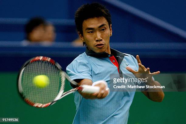 Shao-Xuan Zeng of China returns a shot to Dudi Sela of Israel during day one of the 2009 Shanghai ATP Masters 1000 at Qi Zhong Tennis Centre on...