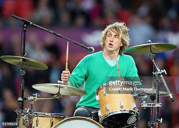 Dan Haggis drumme of The Wombats performs ahead of the the Engage Super League Grand Final between Leeds Rhinos and St Helens at Old Trafford on...