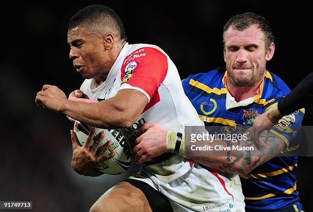 Kyle Eastmond of St Helens is tackled by Jamie Peacock of Leeds Rhinos during the Engage Super League Grand Final between Leeds Rhinos and St Helens...
