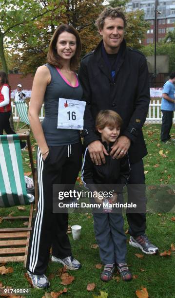 Beverly Turner poses with husband James Cracknell and their son Croyde as she takes part in the Royal Parks Foundation Half Marathon at Hyde Park on...