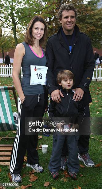 Beverly Turner poses with husband James Cracknell and their son Croyde as she takes part in the Royal Parks Foundation Half Marathon at Hyde Park on...