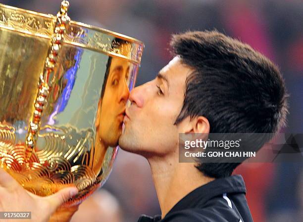 Novak Djokovic of Serbia kisses the trophy during an awards ceremony after beating Marin Cilic of Croatia in the men's final match of the China Open...