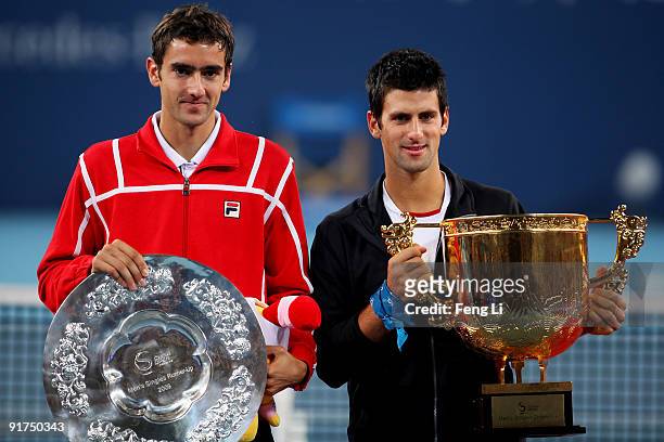 Winner Novak Djokovic of Serbia and Marin Cilic of Croatia pose with their trophies after the men's final match during day ten of the 2009 China Open...