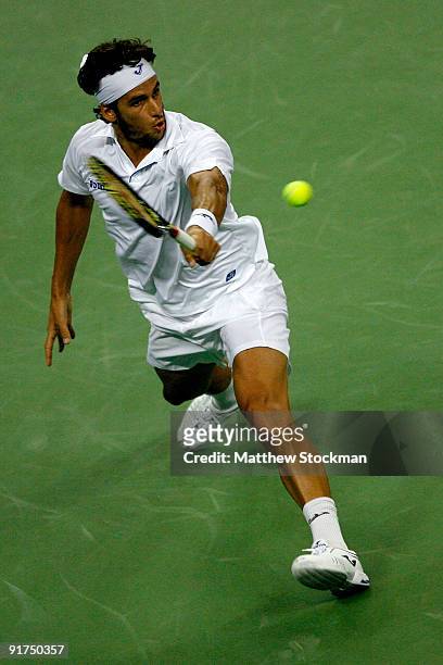 Feliciano Lopez of Spain returns a shot to Guillermo Garcia-Lopez of Spain during day one of the 2009 Shanghai ATP Masters 1000 at Qi Zhong Tennis...