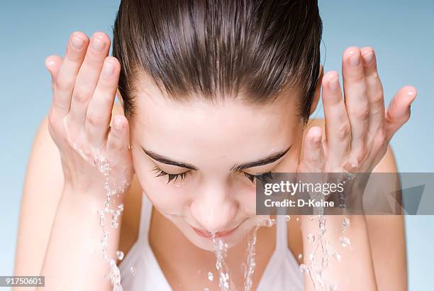 washing face - washing face stock pictures, royalty-free photos & images