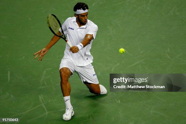 Feliciano Lopez of Spain returns a shot to Guillermo Garcia-Lopez of Spain during day one of the 2009 Shanghai ATP Masters 1000 at Qi Zhong Tennis...