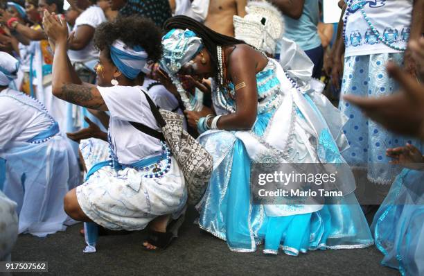 Reveler bows her head during the Afoxe Ile Ala 'bloco', or block party, on February 12, 2018 in Rio de Janeiro, Brazil. The bloco celebrates the...