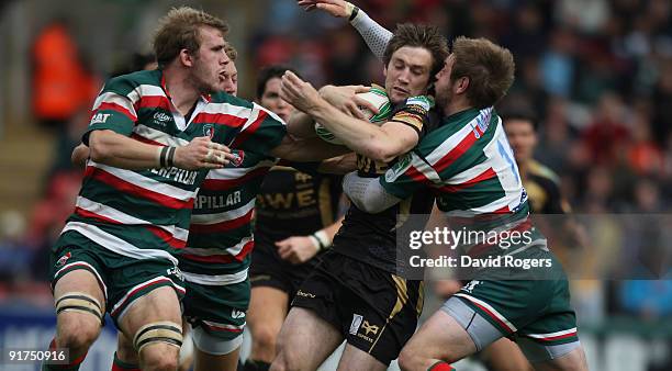 Andrew Bishop of the Ospreys is tackled by Tom Croft and Johne Murphy during the Heineken Cup match between Leicester Tigers and Ospreys at Welford...