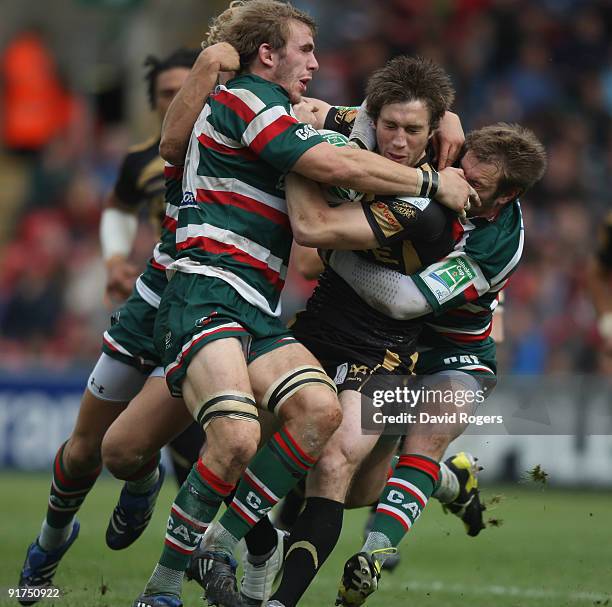 Andrew Bishop of the Ospreys is tackled by Tom Croft and Johne Murphy during the Heineken Cup match between Leicester Tigers and Ospreys at Welford...