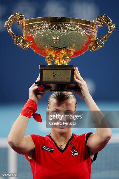 Svetlana Kuznetsova of Russia poses with her trophy after victory in the women's final match against Agnieszka Radwanska on day ten of the 2009 China...