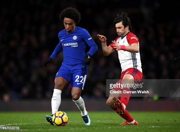 Willian of Chelsea is challenged by Claudio Yacob of West Bromwich Albion during the Premier League match between Chelsea and West Bromwich Albion at...