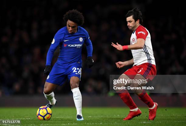 Willian of Chelsea is challenged by Claudio Yacob of West Bromwich Albion during the Premier League match between Chelsea and West Bromwich Albion at...