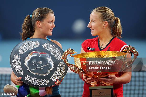 Winner Svetlana Kuznetsova of Russia and opponent Agnieszka Radwanska of Poland pose with their trophies after competing in the women's final match...