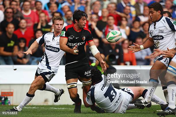 Jean Bouilhou of Toulouse feeds off a pass during the Heineken Cup Pool Five match between Toulouse and Sale Sharks at the Stade Municipial on...