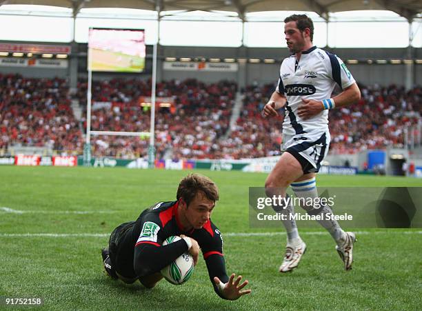 Vincent Clerc of Toulouse scores his sides third try as Nick Macleod of Sale fails to challenge during the Heineken Cup Pool Five match between...