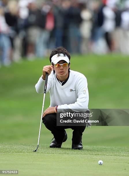 Ryo Ishikawa of Japan and The International Team putts at the 8th hole during the Day Three Afternoon Fourball Matches in The Presidents Cup at...