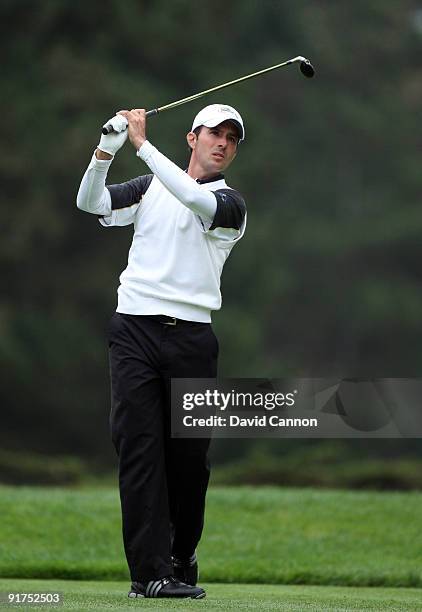 Mike Weir of Canada and the International Team tees off at the 13th hole during the Day Three Afternoon Fourball Matches in The Presidents Cup at...