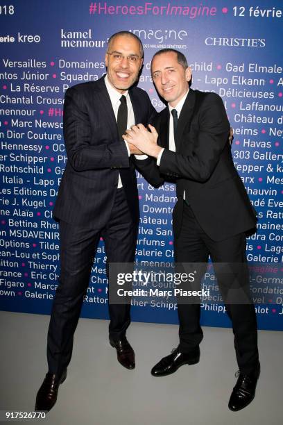 Kamel Mennour and actor Gad Elmaleh attend the 'Heroes for Imagine' host by Kamel Mennour benefit auction at L'Institut Imagine on February 12, 2018...