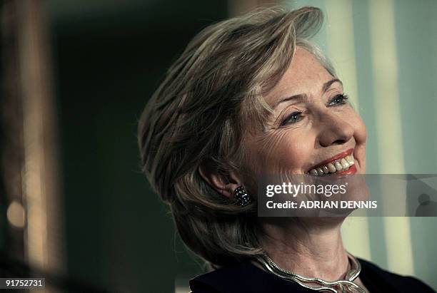 Secretary of State Hillary Rodham Clinton smiles broadly during a press conference with her British counterpart David Miliband at No.1 Carlton...
