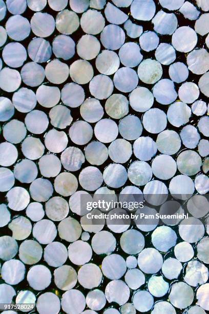 abstract close-up of mother-of-pearl discs applied to pottery - mother of pearl stock pictures, royalty-free photos & images