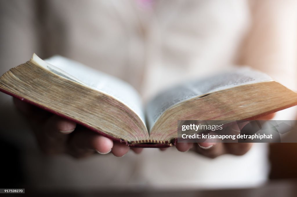 Woman reading holy bible.