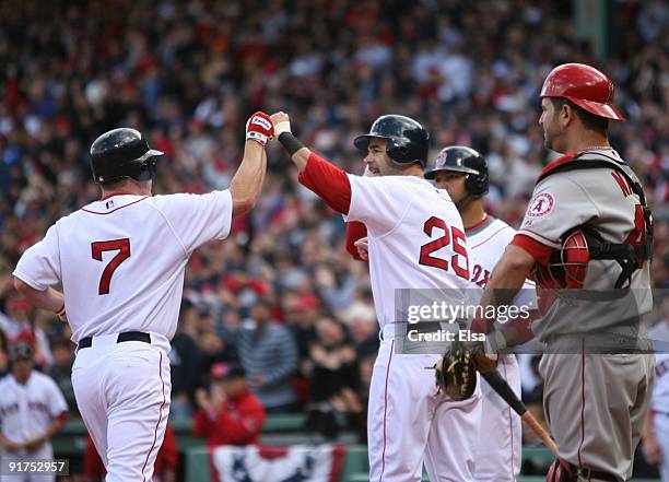 Drew of the Boston Red Sox celebrates at home plate with Mike Lowell after hitting a two run home run to score Lowell in the fourth inning of Game...