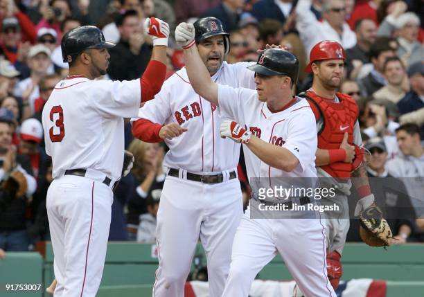 Drew of the Boston Red Sox celebrates with teammates Alex Gonzalez and Mike Lowell as Mike Napoli of the Los Angeles Angels of Anaheim looks on after...