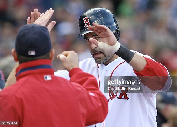 Mike Lowell of the Boston Red Sox celebrates with teammates after scoring a run on a J.D. Drew two-run home run in the fourth inning against the Los...