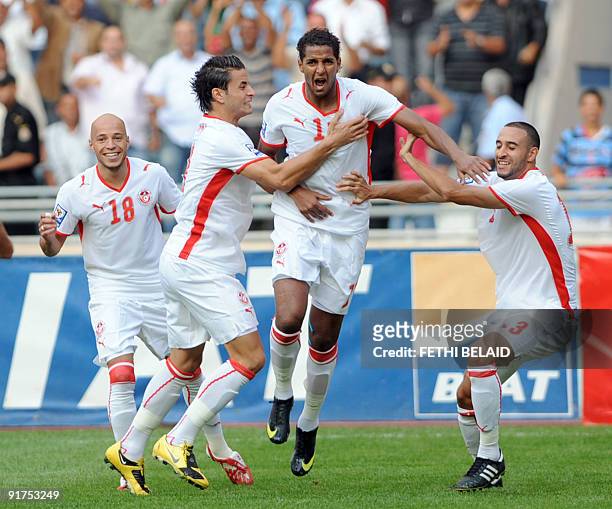 Tunisia's Yassine Mikari, Khaled Korbi, Issam Jomaa and Nabil Tayder celebrate after scoring against Kenya during their 2010 World Cup-African...