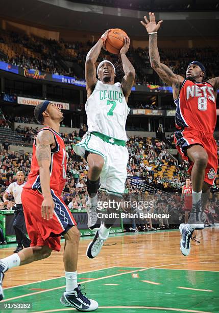 Marquis Daniels of the Boston Celtics drives to the basket against Terrence Williams of the New Jersey Nets during an NBA preseason game on October...