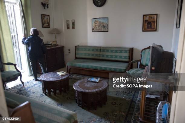 Rubina Tashjian, the widow of the last owner of Aleppo's Baron Hotel, opens the curtains in the presidential suite, where some of the Syrian...