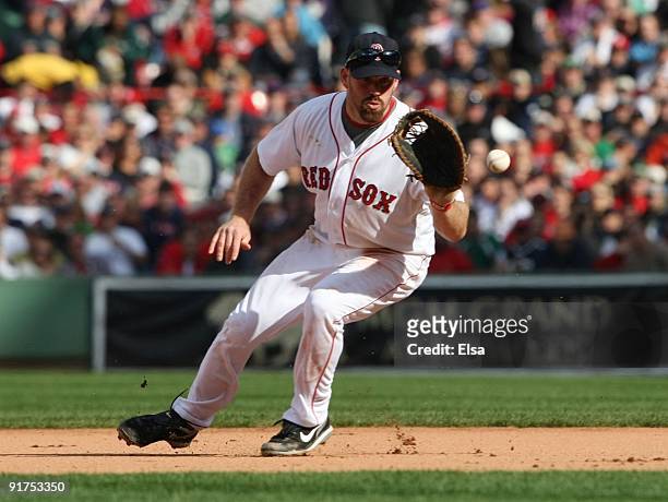 Kevin Youkilis of the Boston Red Sox fields a hit by Erick Aybar of the Los Angeles Angels of Anaheim in the seventh inning, Aybar out at first in...