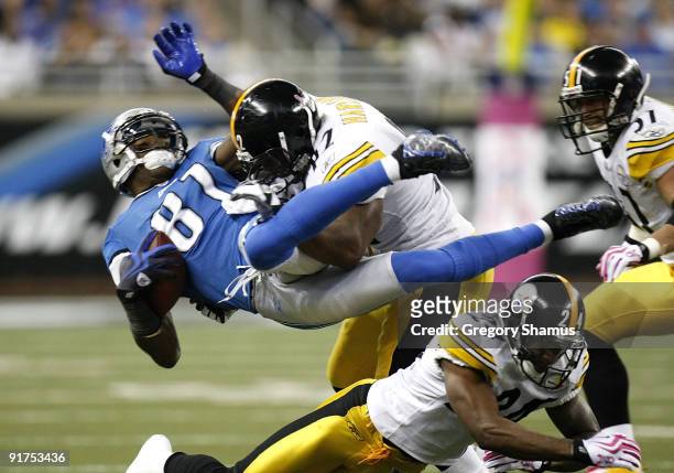 Calvin Johnson of the Detroit Lions is tackled by James Harrison of the Pittsburgh Steelers October 11, 2009 at Ford Field in Detroit, Michigan....
