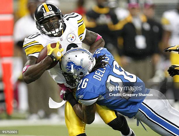 Santonio Holmes of the Pittsburgh Steelers is tackled after making a second quarter catch by Louis Delmas of the Detroit Lions on October 11, 2009 at...