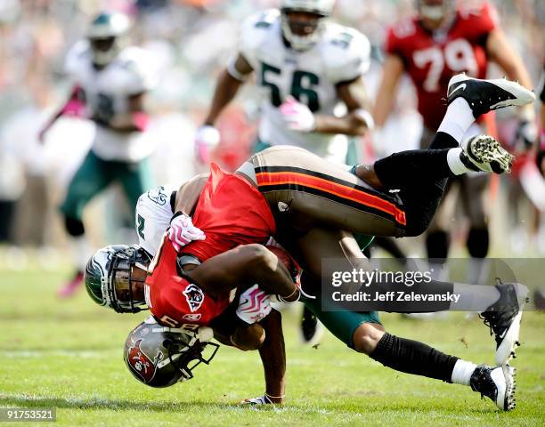 Joselio Hanson of the Philadelphia Eagles tackles Antonio Bryant of the Tampa Bay Buccaneers at Lincoln Financial Field on October 11, 2009 in...