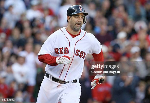 Mike Lowell of the Boston Red Sox runs to first after he hits a RBI single in the eighth inning against the Los Angeles Angels of Anaheim in Game...