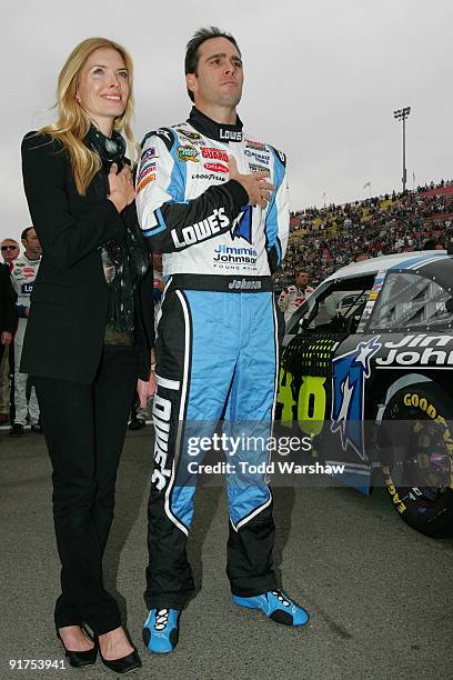 Chandra Johnson and Jimmie Johnson , driver of the Lowe's/Jimmie Johnson Foundation Chevrolet, stand on pit road during the national anthem before...