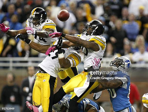 Ryan Clark, Ryan Mundy and Ike Taylor of the Pittsburgh Steelers break up a pass in the end zone intended for Bryant Johnson of the Detroit Lions on...