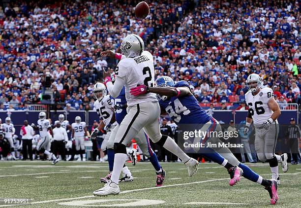 Mathias Kiwanuka of the New York Giants forces a fumble against JaMarcus Russell of the Oakland Raiders on October 11, 2009 at Giants Stadium in East...