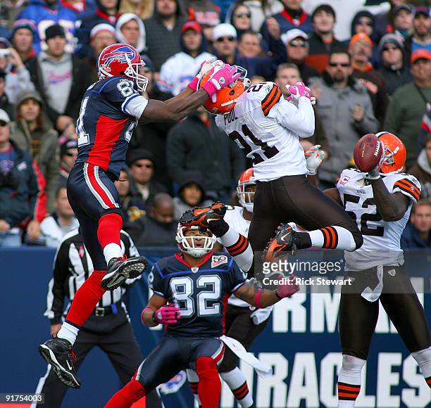Terrell Owens of the Buffalo Bills defends against Brodney Pool of the Cleveland Browns as Josh Reed of the Bills watches at Ralph Wilson Stadium on...