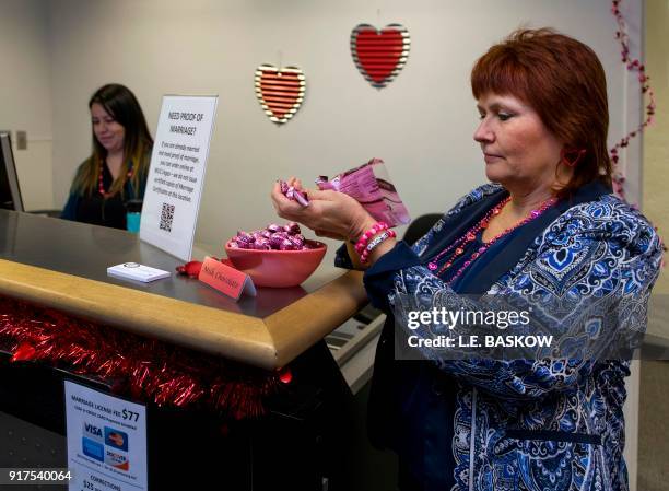Paula Cook with the Clark County Clerk's Office refills a candy dish as she helps operates a temporary pop-up marriage license office at McCarran...