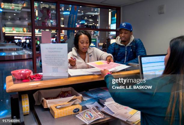 Teaira Thompson and James Anderson of Burlington, Iowa, complete their paperwork as the Clark County Clerk's Office operates a temporary pop-up...