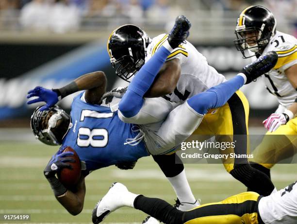 Calvin Johnson of the Detroit Lions is tackled by James Harrison of the Pittsburgh Steelers October 11, 2009 at Ford Field in Detroit, Michigan....