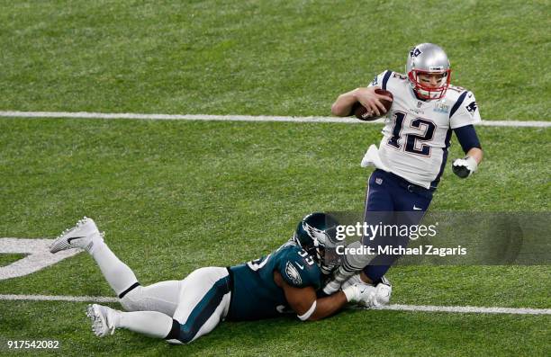 Brandon Graham of the Philadelphia Eagles tackles Tom Brady of the New England Patriots in Super Bowl LII at U.S. Bank Stadium on February 4, 2018 in...