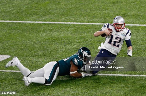 Brandon Graham of the Philadelphia Eagles tackles Tom Brady of the New England Patriots in Super Bowl LII at U.S. Bank Stadium on February 4, 2018 in...