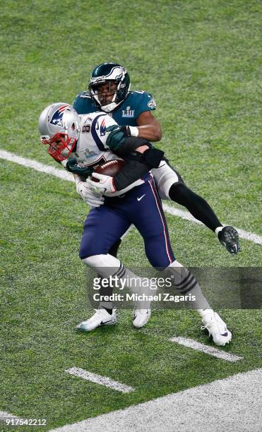 Rob Gronkowski of the New England Patriots makes a reception as Corey Graham of the Philadelphia Eagles tackles him in Super Bowl LII at U.S. Bank...