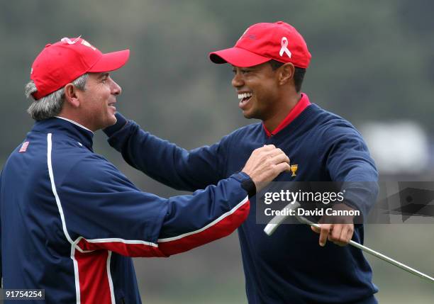 Fred Couples the Captain of the USA Team races to congratulate Tiger Woods after he had holed the winning putt at the 13th hole where he beat his...